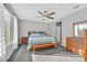 Comfortable bedroom with a ceiling fan, carpeted floor, and a window with bright natural light at 2383 Elmont Ave, North Las Vegas, NV 89086