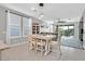 Inviting dining area with white table, chairs, and stylish pendant lighting open to the great room and backyard at 2383 Elmont Ave, North Las Vegas, NV 89086