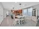 Open concept dining area with tile flooring, contemporary lighting, and adjacent kitchen at 2383 Elmont Ave, North Las Vegas, NV 89086