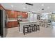 Modern kitchen with a center island, stainless steel appliances, and an open layout to the dining and living areas at 2383 Elmont Ave, North Las Vegas, NV 89086