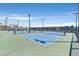Well-maintained community tennis courts with lights for evening play under a sunny sky at 2383 Elmont Ave, North Las Vegas, NV 89086