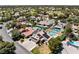 Aerial view of a neighborhood featuring houses, green lawns, swimming pools, and palm trees at 2425 Greens Ave, Henderson, NV 89014