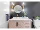 Well-lit bathroom featuring modern fixtures, a gold mirror, and contemporary finishes at 2425 Greens Ave, Henderson, NV 89014