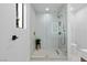 Bathroom with seamless glass shower enclosure, patterned tile, and updated fixtures at 2425 Greens Ave, Henderson, NV 89014