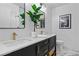 Stylish bathroom featuring double sinks, marble countertops, and modern fixtures with green plants at 2425 Greens Ave, Henderson, NV 89014