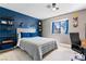 Cozy bedroom featuring a large bed, blue accent wall, and decor shelves at 2425 Greens Ave, Henderson, NV 89014