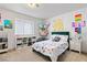Bright bedroom with playful decor, white walls, a large window, and modern furnishings at 2425 Greens Ave, Henderson, NV 89014