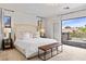 Bedroom with a balcony featuring neutral decor and bright natural light at 2425 Greens Ave, Henderson, NV 89014
