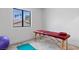 Bonus room with massage table, yoga ball, exercise mat, and large window with greenery view at 2425 Greens Ave, Henderson, NV 89014
