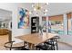 Bright dining area featuring a modern light fixture and backyard pool view at 2425 Greens Ave, Henderson, NV 89014