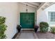 Elegant home entrance with charming double doors, a welcoming path, and delightful landscaping at 2425 Greens Ave, Henderson, NV 89014