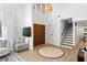 Bright entryway featuring a high ceiling, staircase, and modern decor at 2425 Greens Ave, Henderson, NV 89014