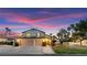 Charming two-story home with a well-manicured lawn, mature trees, and a spacious three-car garage at 2425 Greens Ave, Henderson, NV 89014