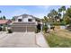 Two-story home featuring a three-car garage, solar panels, and desert landscaping at 2425 Greens Ave, Henderson, NV 89014