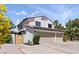 Home with a three-car garage and desert landscaping at 2425 Greens Ave, Henderson, NV 89014