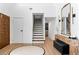 Welcoming home foyer with a stylish console table, modern lighting, and a beautiful staircase at 2425 Greens Ave, Henderson, NV 89014