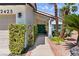 Home's front yard featuring a garden-lined walkway that leads to a green front door at 2425 Greens Ave, Henderson, NV 89014