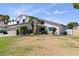 Two-story home showcasing a large front yard with desert landscaping and a three-car garage at 2425 Greens Ave, Henderson, NV 89014