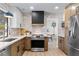 Modern kitchen featuring stainless steel appliances, custom cabinetry, and stylish backsplash at 2425 Greens Ave, Henderson, NV 89014