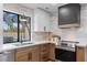Modern kitchen featuring stainless steel appliances, a black range hood, and view of pool at 2425 Greens Ave, Henderson, NV 89014
