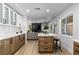 Open kitchen with an island and seating adjacent to the living room at 2425 Greens Ave, Henderson, NV 89014