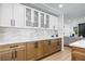 Elegant kitchen showcasing custom cabinets, sleek countertops, and a view into the living area at 2425 Greens Ave, Henderson, NV 89014