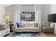 Cozy living room showcasing a stylish sofa, large window, and bright natural light at 2425 Greens Ave, Henderson, NV 89014