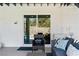 Outdoor patio with cozy seating, sliding glass doors, and tranquil pool views at 2425 Greens Ave, Henderson, NV 89014