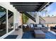 This covered patio features outdoor seating, a blue rug, and access to a second floor at 2425 Greens Ave, Henderson, NV 89014