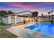 Backyard view showcasing a diving board, pool, outdoor seating, and the home's exterior at 2425 Greens Ave, Henderson, NV 89014