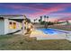 Backyard with pool and diving board, showcasing outdoor seating and lawn at 2425 Greens Ave, Henderson, NV 89014