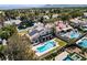 Aerial view of a house with a large yard, swimming pool, lounge chairs and solar panels on roof at 2425 Greens Ave, Henderson, NV 89014