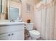 Cozy bathroom featuring a floral shower curtain, ample storage, and modern fixtures at 2509 Libretto Ave, Henderson, NV 89052