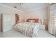 Bright bedroom features striped wallpaper, a comfortable bed, and a well-lit en-suite bathroom at 2509 Libretto Ave, Henderson, NV 89052
