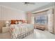 Bright bedroom with stylish bedding, a ceiling fan, and a large window that provides plenty of natural light at 2509 Libretto Ave, Henderson, NV 89052