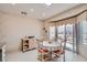Cozy breakfast nook with a view of the outdoor patio and white painted chairs at 2509 Libretto Ave, Henderson, NV 89052