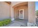 Covered entry featuring a white front door with decorative wreath and sidelight at 2509 Libretto Ave, Henderson, NV 89052