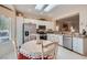 Well-lit kitchen with stainless steel appliances and granite countertop adjacent to dining nook at 2509 Libretto Ave, Henderson, NV 89052