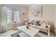 Bright living room features a comfortable sofa, area rug, and natural light from the window at 2509 Libretto Ave, Henderson, NV 89052
