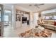 Open concept living room with tile floors, built-in shelving and media center at 2509 Libretto Ave, Henderson, NV 89052