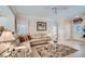 Bright living room with tile flooring, skylight, and comfortable seating arrangement at 2509 Libretto Ave, Henderson, NV 89052