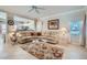Comfortable living room with tile flooring, neutral colors, and a view into the kitchen at 2509 Libretto Ave, Henderson, NV 89052