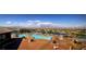 Expansive community pool area with lounge chairs, umbrellas, and stunning views of the surrounding desert landscape at 2509 Libretto Ave, Henderson, NV 89052