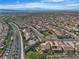 Expansive aerial shot featuring countless homes, streets, and mountain views in the distance at 2554 Braehead Ln, Henderson, NV 89044