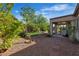 Backyard featuring a covered patio, garden, stone ground cover, and manicured lawn at 2554 Braehead Ln, Henderson, NV 89044