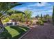 Expansive backyard featuring a sparkling pool, lush lawn, and mature landscaping for outdoor enjoyment and relaxation at 2554 Braehead Ln, Henderson, NV 89044