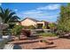 Picturesque backyard featuring a sparkling pool, lush greenery, and colorful flowers, perfect for outdoor entertaining at 2554 Braehead Ln, Henderson, NV 89044