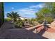 Serene backyard with lush landscaping, mature trees, and charming water feature, creating a tranquil outdoor retreat at 2554 Braehead Ln, Henderson, NV 89044