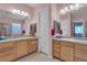 Bright bathroom with double sinks, stylish mirrors, and ample counter space on wooden cabinets at 2554 Braehead Ln, Henderson, NV 89044