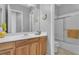 Bright bathroom featuring a shower/tub, mirror and wood vanity with ample counter space at 2554 Braehead Ln, Henderson, NV 89044